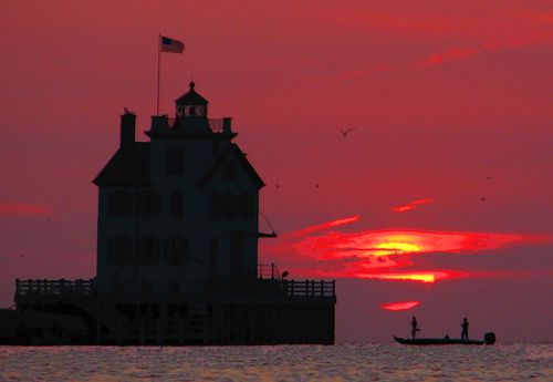 Fishermen catch the sunset at the Lorain lighthouse
