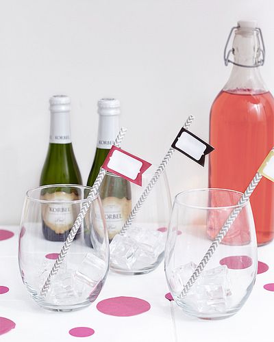 stemless wine glasses with champagne and pink lemonade and cocktail stirrers with little flags